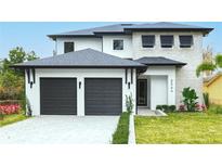 Two-story home with modern facade, two-car garage, and landscaped lawn at 6564 Lagoon St, Windermere, FL 34786