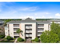 Three-story building with balconies and lush landscaping at 1368 Centre Court Ridge Dr # 104, Reunion, FL 34747