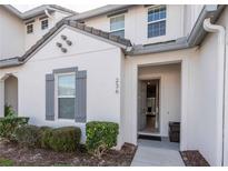 Charming townhouse featuring well-maintained landscaping, a grey shuttered window and a welcoming front entrance at 236 Captiva Dr, Davenport, FL 33896
