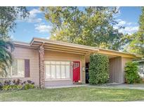 Charming ranch home with red door and well-manicured lawn at 525 S Lakemont Ave, Winter Park, FL 32792