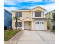 Two-story house with a white door and driveway at 1266 Sandestin Way, Orlando, FL 32824