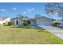 Single-story home with a white garage door and landscaped lawn at 1101 Swanson Dr, Deltona, FL 32738