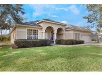 Charming single-story home featuring manicured landscaping and a two-car garage at 268 Heatherbrooke Cir, Oviedo, FL 32765