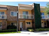 Modern two-story townhome with stone accents and private balcony at 3206 Brasilia Ave, Kissimmee, FL 34747