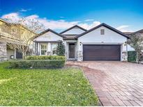 Two-story house with a brick paved walkway, a two-car garage, and well-manicured lawn at 3465 Middlebrook Pl, Harmony, FL 34773