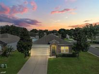 Attractive one-story house with a landscaped lawn, at dusk at 745 Andrew St, Eustis, FL 32726