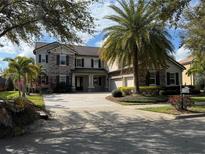 Beautiful two-story home with stone accents, shuttered windows and lush landscaping at 15041 Gaulberry Run, Winter Garden, FL 34787