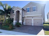 Two-story house with a three-car garage and landscaping at 15306 Southern Martin St, Winter Garden, FL 34787