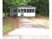 Gray house with screened porch, and a yard at 2204 Suanee Ave, Eustis, FL 32726