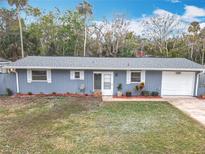 Newly renovated home with gray siding, white shutters, and landscaped lawn at 608 Powers Ave, Port Orange, FL 32127