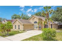 Charming single-Gathering home with well-maintained landscaping and a spacious driveway at 905 Hatteras Ave, Minneola, FL 34715