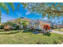 Charming home featuring a well-manicured lawn, lush landscaping, and a beautiful tiled roof at 10812 Woodchase Cir, Orlando, FL 32836
