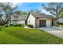 Charming single Gathering home featuring a well-manicured lawn and attached garage at 123 Golf Club Dr, Longwood, FL 32779