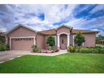 One-story house with attached garage, manicured lawn, and well-maintained landscaping at 1380 Normandy Heights Cir, Winter Haven, FL 33880