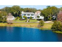 Aerial view of a waterfront home with lush landscaping at 1522 Lake Knowles Cir, Winter Park, FL 32789