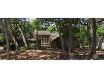 Two-story house with brick facade and large windows, nestled among mature trees at 1542 Sugarwood Cir, Winter Park, FL 32792