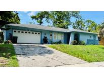 Ranch style home with attached garage and well-maintained lawn at 1854 Sepalwood Ct, Orlando, FL 32818