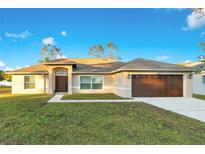 One-story home with brown garage door and landscaped lawn at 20493 Majestic St, Orlando, FL 32833