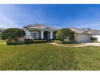 Single-story house with a two-car garage, manicured lawn and landscaping at 346 Hickory Springs Ct, Debary, FL 32713