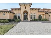 Stunning Mediterranean-style home featuring a grand front entrance and a paved driveway at 3764 Farm Bell Pl, Lake Mary, FL 32746