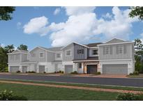 Modern townhome with two-tone exterior and attached garage at 4299 Campsite Loop, Orlando, FL 32824