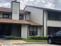 Exterior view of condo building, showing building facade and parking at 4653 Cason Cove Dr # 2713, Orlando, FL 32811