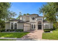 Stunning two-story home with brick driveway and manicured landscaping at 5265 Forest Edge Ct, Sanford, FL 32771