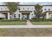 Two-story townhome with front porch and landscaped yard at 9737 Amber Chestnut Way, Winter Garden, FL 34787