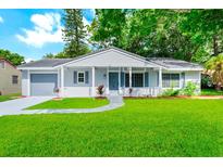 Charming single-story home with a well-manicured lawn, cozy front porch, and attached garage at 10118 Allenby Ct, Orlando, FL 32821