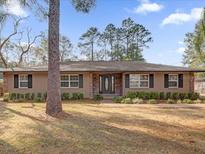 Tan house with stone accents, landscaping, and a spacious lawn at 126 Se 41St Ave, Ocala, FL 34471