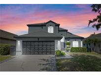 Charming two-story home with a well-manicured lawn, beautiful windows, and a spacious two-car garage at 127 Westmoreland Cir, Kissimmee, FL 34744
