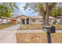 Charming single-story home featuring a covered parking area and a well-maintained front yard at 1335 Lescot Ln, Orlando, FL 32811