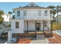 Two-story house with white exterior, brown deck, and black accents at 17 S Oleander Ave, Daytona Beach, FL 32118