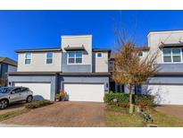 Modern two-story townhome with two-car garage and landscaped front yard at 2229 Shadowland Loop, Winter Park, FL 32792