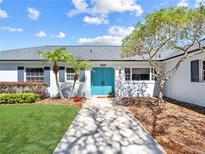 Charming single-story home featuring a beautiful blue front door, manicured lawn, and mature trees at 2459 Hunterfield Rd, Maitland, FL 32751