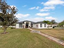 Single-story home with a landscaped yard and walkway at 2869 Blush Dr, Lakeland, FL 33813