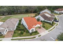 Charming corner lot home with well-maintained landscaping and distinctive terracotta roof at 2977 Rapollo Ln, Apopka, FL 32712