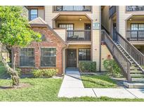 Brick and wood exterior of condo building with stairs and walkway at 305 Lakepointe Dr # 101, Altamonte Springs, FL 32701