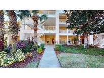 Inviting condo building with lush landscaping and walkway at 702 Rum Run # 38702, Davenport, FL 33897