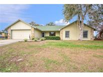 Ranch style home with a green roof, attached garage, and a spacious yard at 1220 Alden Ter, Deltona, FL 32738