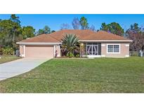 Single-story home with a brown roof, attached garage, and landscaped yard at 18433 Reynolds Pkwy, Orlando, FL 32833