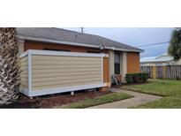 Tan colored exterior wall and walkway next to an orange building at 42 Silver Oak Cir, Kissimmee, FL 34743