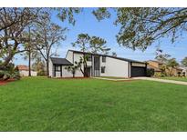 Stunning two-story home with modern exterior and manicured lawn at 4940 Spring Run Ave, Orlando, FL 32819