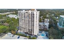 Aerial view of a high rise building, pool, and parking lot at 530 E Central Blvd # 603, Orlando, FL 32801