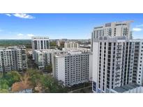 Stunning aerial view of the city skyline with modern high-rise apartment buildings and beautiful blue sky at 530 E Central Blvd # 603, Orlando, FL 32801