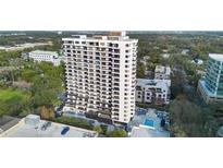 Contemporary high-rise condo with balconies, poolside patio, and parking, surrounded by lush landscaping and city views at 530 E Central Blvd # 603, Orlando, FL 32801