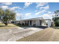 Single story home with carport and mature landscaping at 1074 Gerona Ave, Deltona, FL 32725