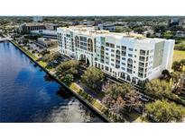 Aerial view of a waterfront condo building with parking and water access at 225 W Seminole Blvd # 412, Sanford, FL 32771