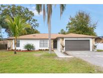 Updated single-story home with stone accents and a two-car garage at 2661 Ames Haven Rd, Kissimmee, FL 34744