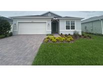 Charming single-story home with a well-manicured lawn and brick driveway at 2753 Redblush Ter, St Cloud, FL 34772